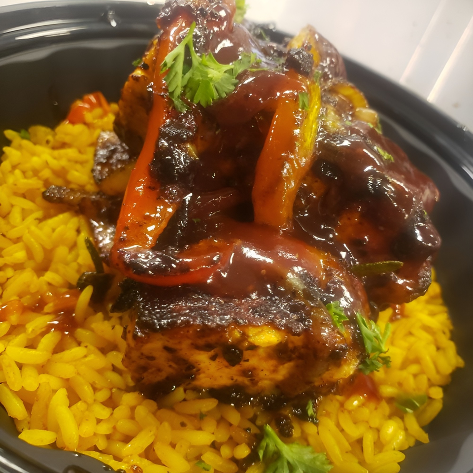 LuvPlates Soul & Grill's American cuisine: chicken and peppers in sauce over yellow rice.